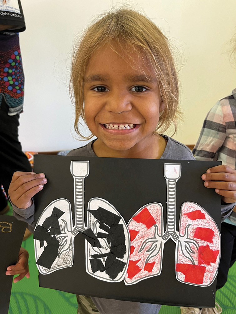 child holding up illustration of lungs