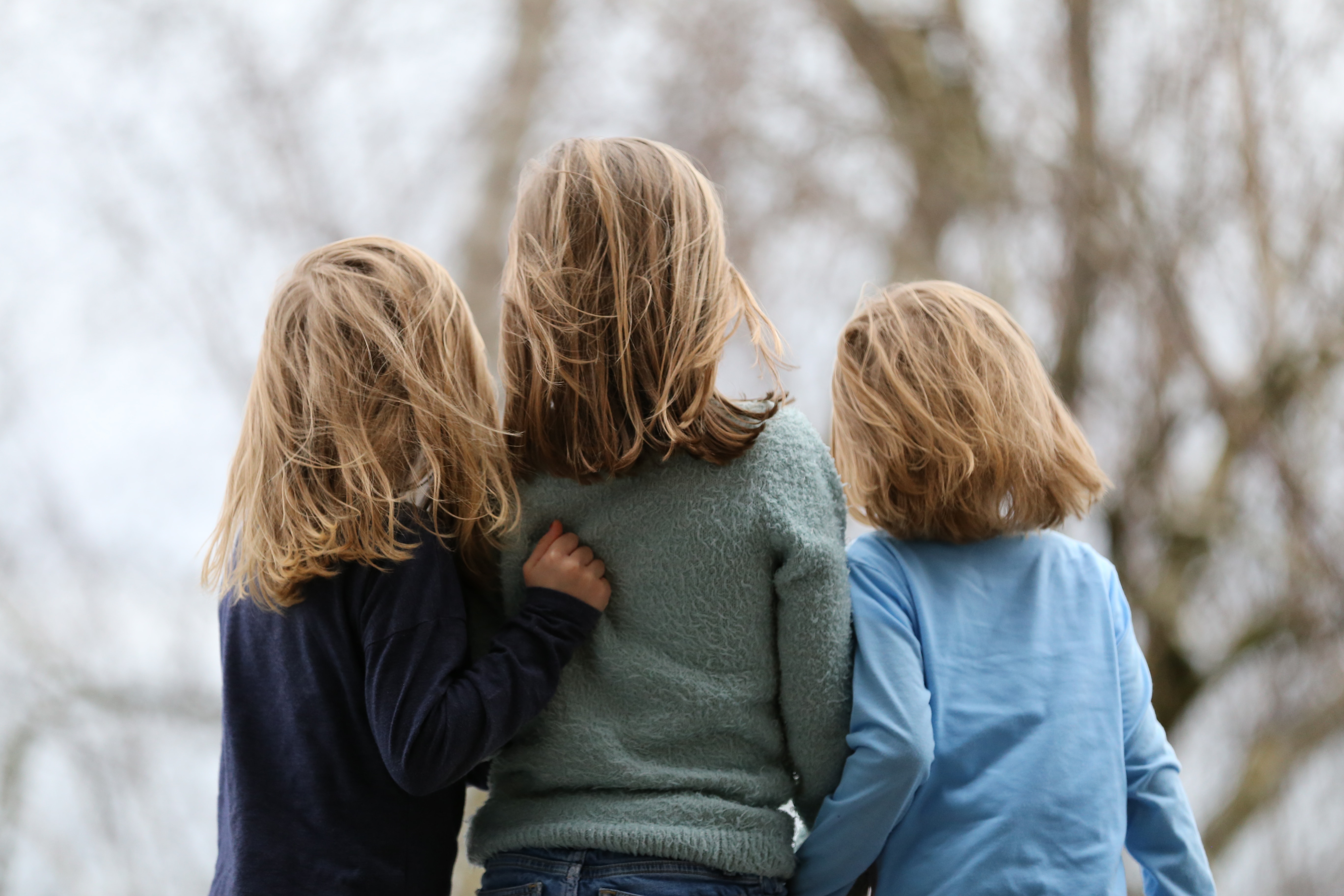 3 kids standing outside