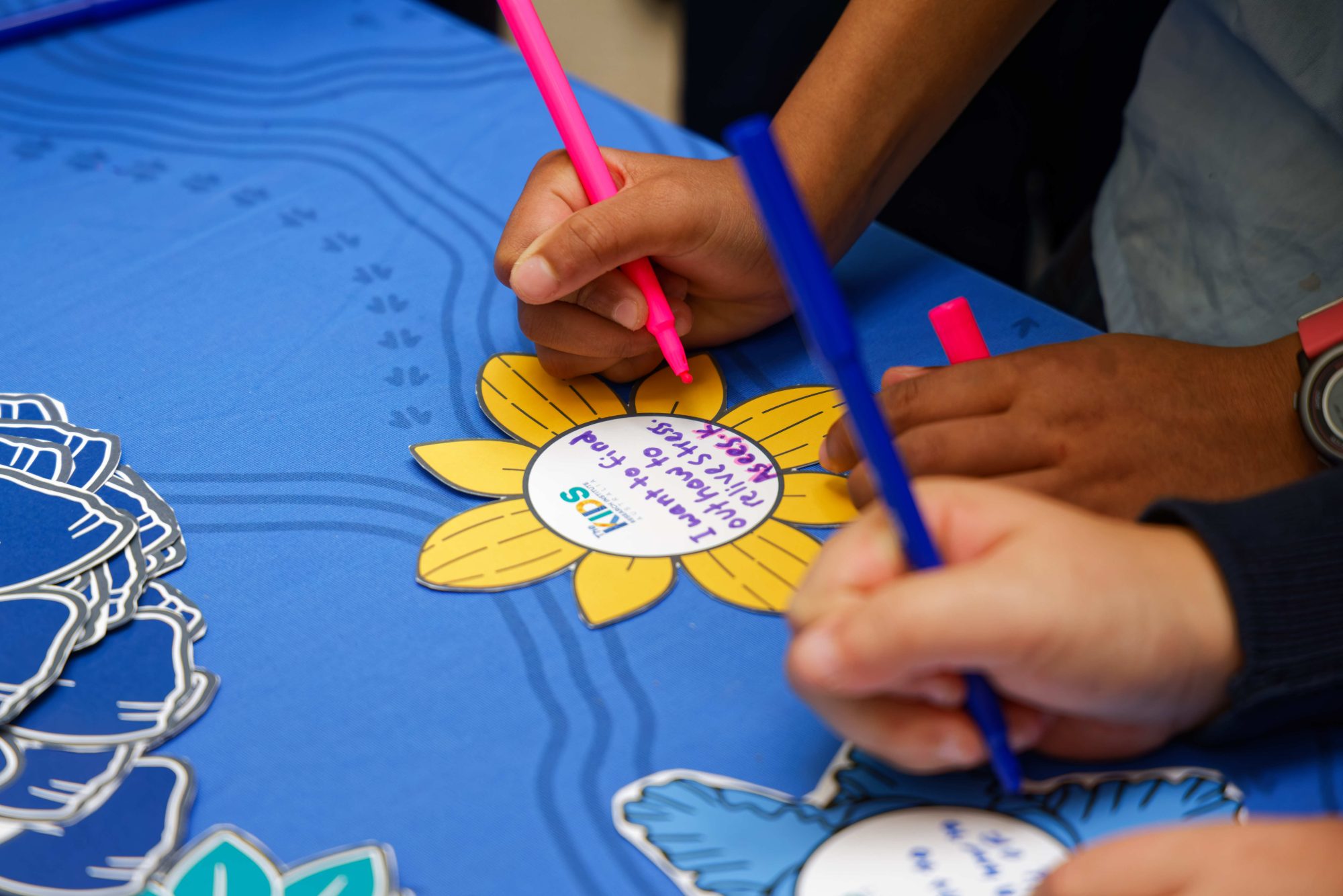 child writing on a flower