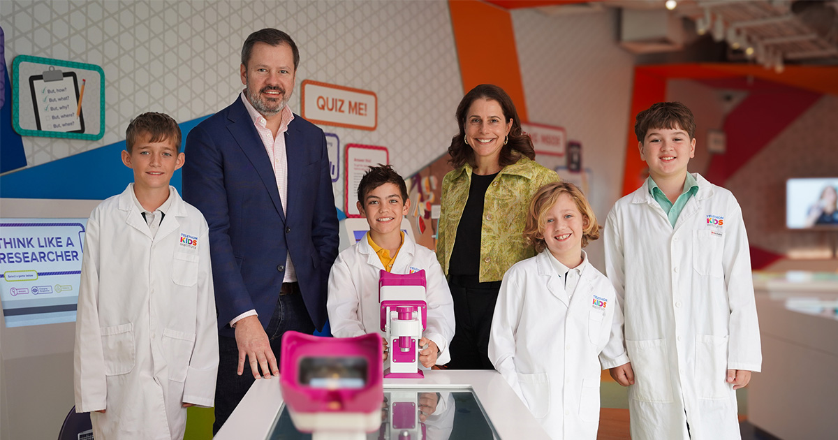 The Hon Ed Husic MP, Professor Catherine Elliott, and some kids in the The Kids Discovery Centre